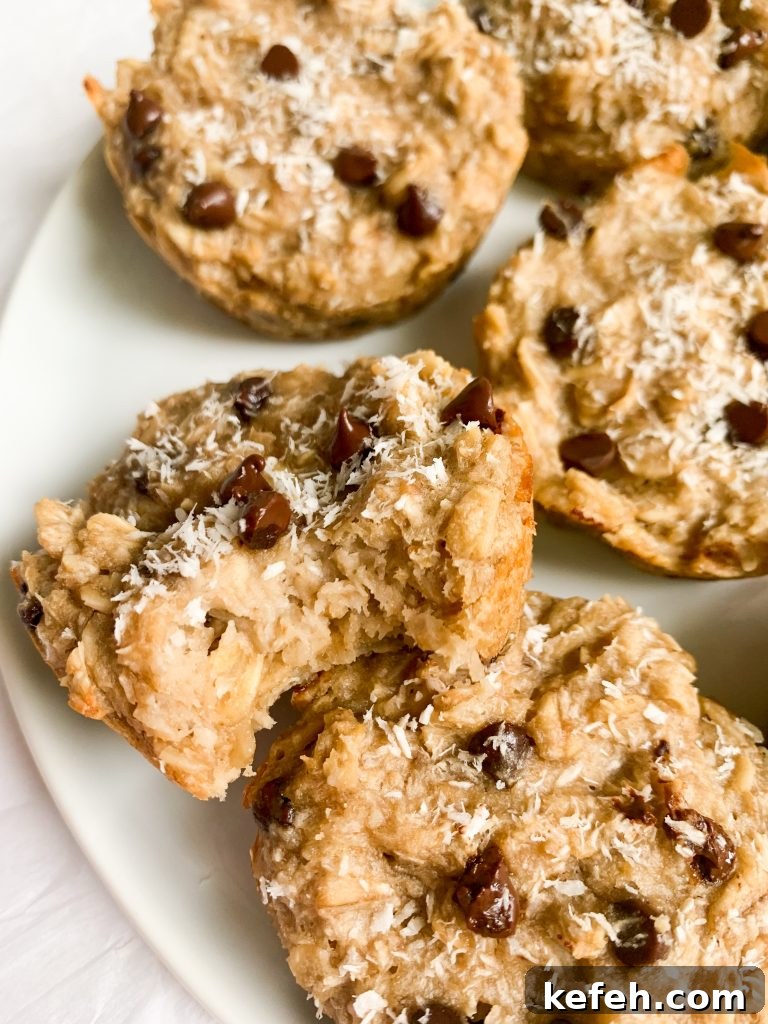 Coconut Cashew Oatmeal Breakfast Cups 7 a plate of oatmeal cups, one with a bite taken out