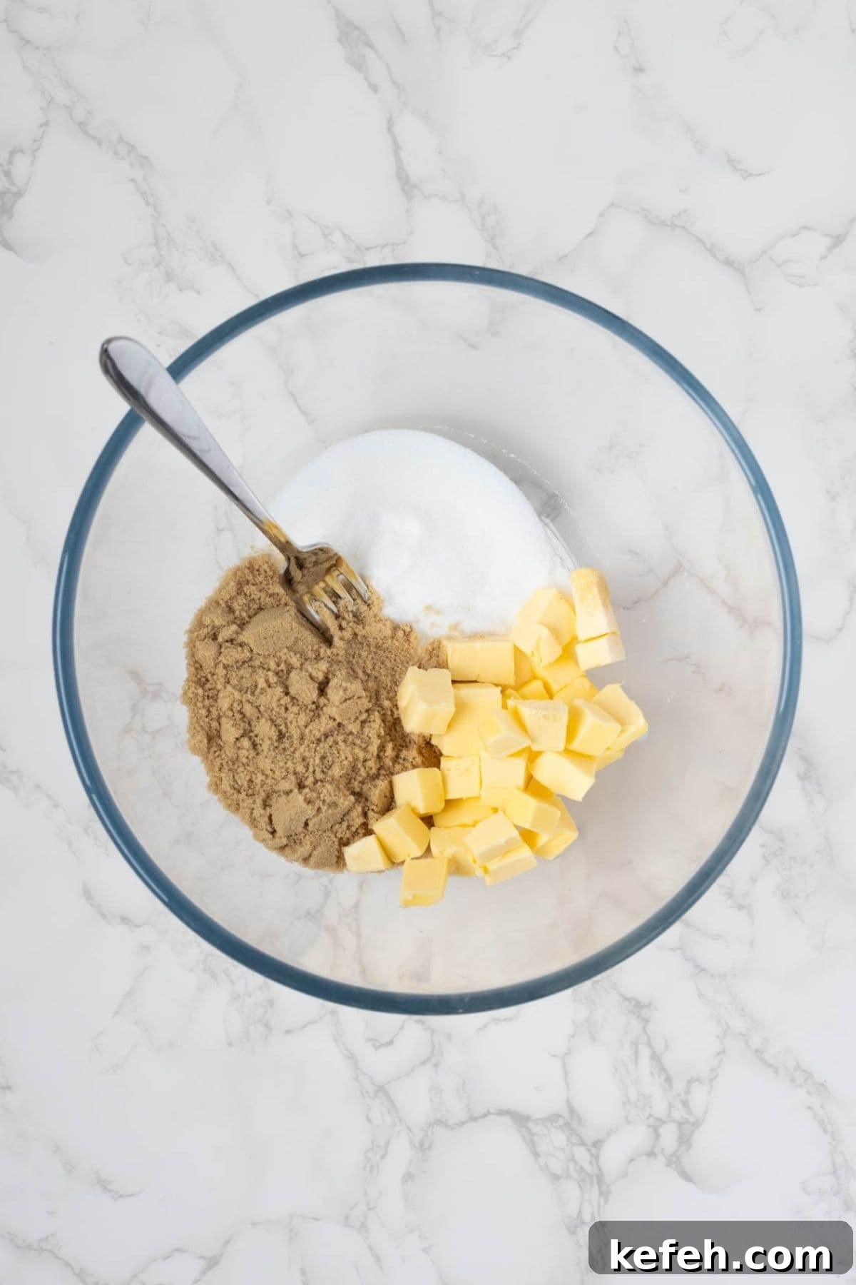 Butter, brown sugar, and white sugar in a mixing bowl before creaming for sourdough peanut butter cookies.