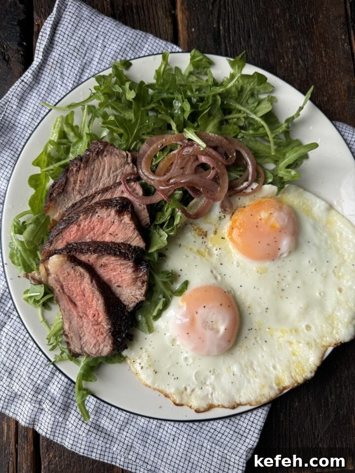 T-Bone Steak Recipe with Garlic Butter and Herbs 9 Juicy steak and eggs with fresh greens, caramelized onions, on a rustic wooden table.