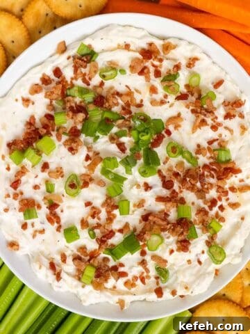 Smoked gouda cheese dip topped with bacon bits and green onion.