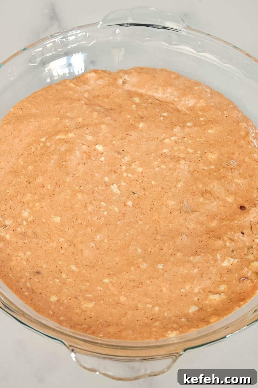 Cream Cheese Salsa Dip Recipe for Parties and Game Day 5 The blended cream cheese and salsa base spread evenly in a glass pie dish before toppings are added.