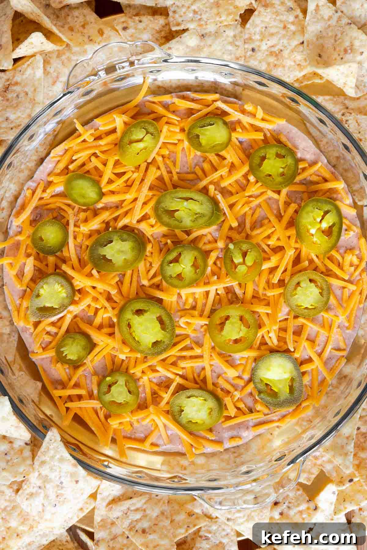 Cream Cheese Salsa Dip Recipe for Parties and Game Day 7 Overhead view of the finished cream cheese and salsa dip garnished with cheese and jalapeños, surrounded by tortilla chips.
