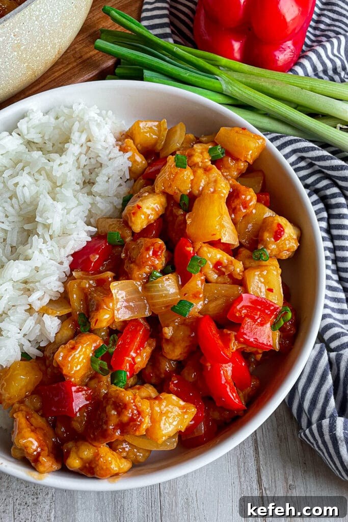 Copycat Panda Express Sweet Fire Chicken Recipe You Can Make at Home 2 easy copycat panda express sweet fire chicken in a white bowl served with white rice.