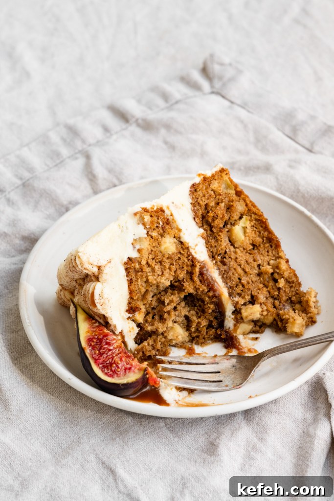 Warm Caramel Apple Spice Cake Recipe 11 Slice of apple cake on a plate with a bite missing.