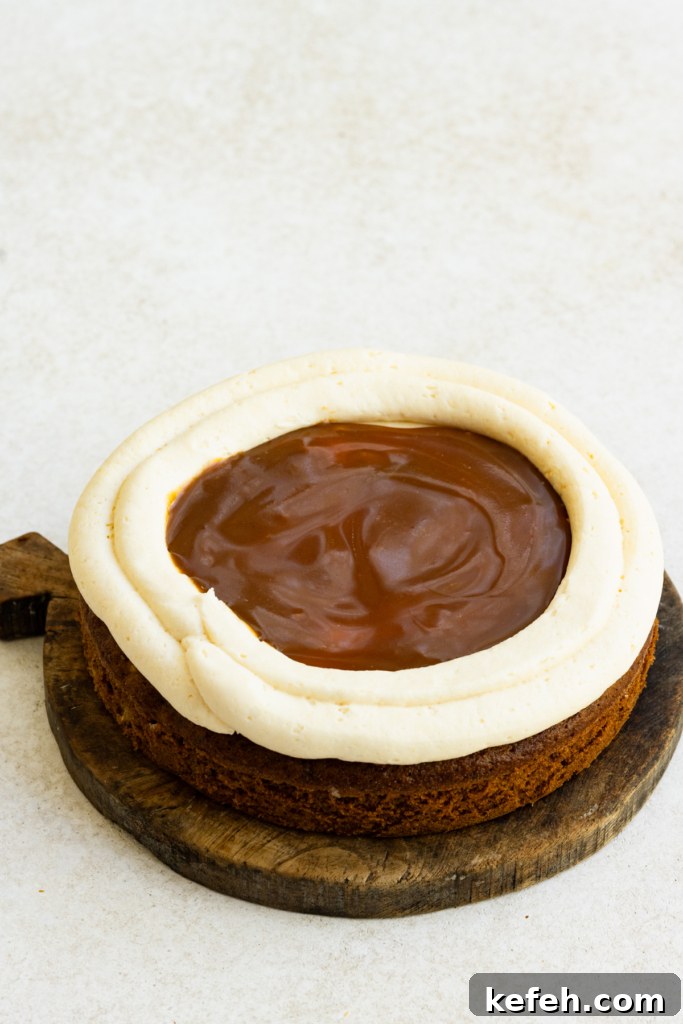 Warm Caramel Apple Spice Cake Recipe 9 Single layer of cake with two rings of buttercream frosting piped on top and caramel sauce in the middle.