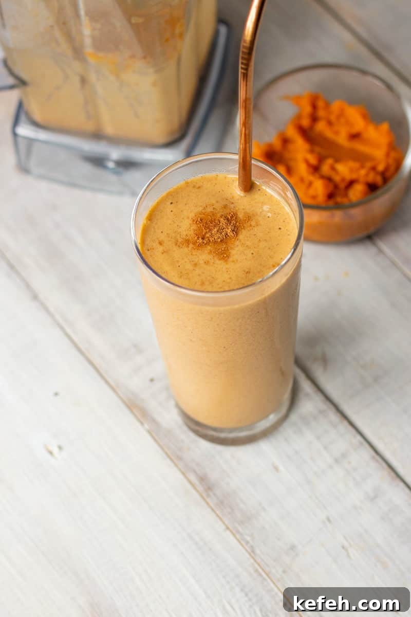 Pumpkin Spice Latte Smoothie Recipe for Fall Morning Energy 2 Pumpkin Spice Latte Smoothie in tall glass next to blender