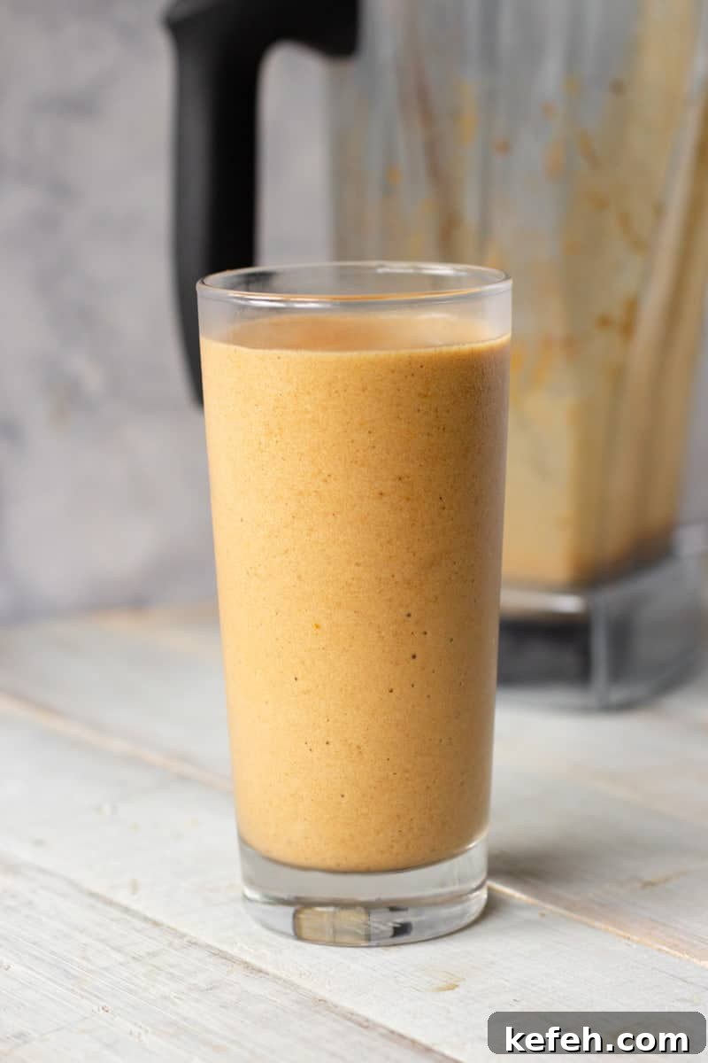 Pumpkin Spice Latte Smoothie Recipe for Fall Morning Energy 6 Pumpkin Spice Latte Smoothie in tall glass in front of blender