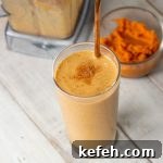 Pumpkin Spice Latte Smoothie in Glass next to bowl of canned pumpkin