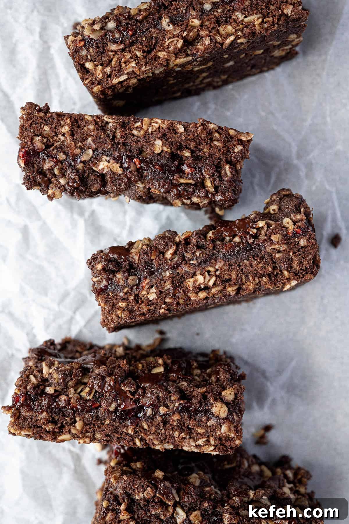 Chocolate raspberry crumble bars in a row.
