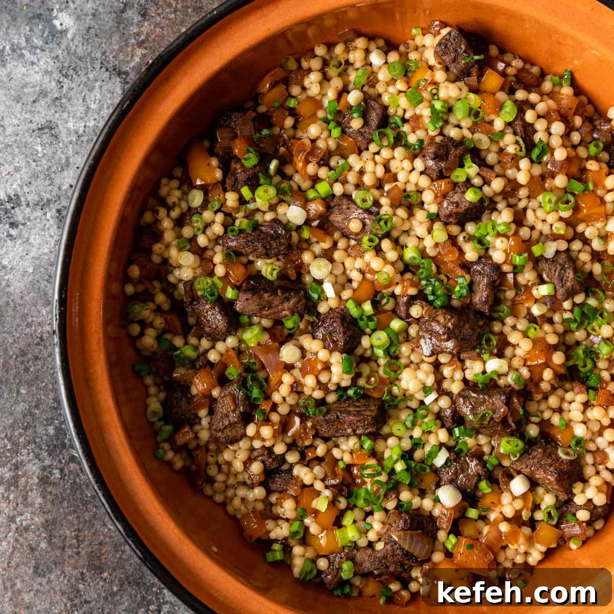 closeup overhead: lamb and couscous in serving dish