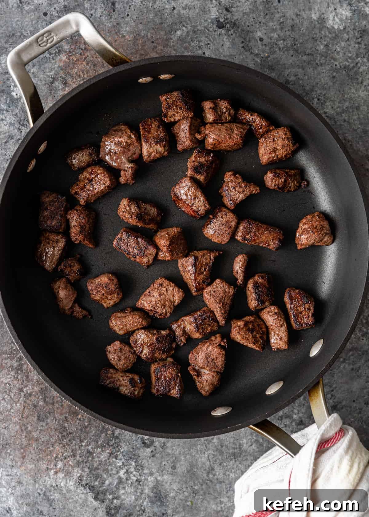 overhead process shot: titled image (and shown) brown the seasoned lamb
