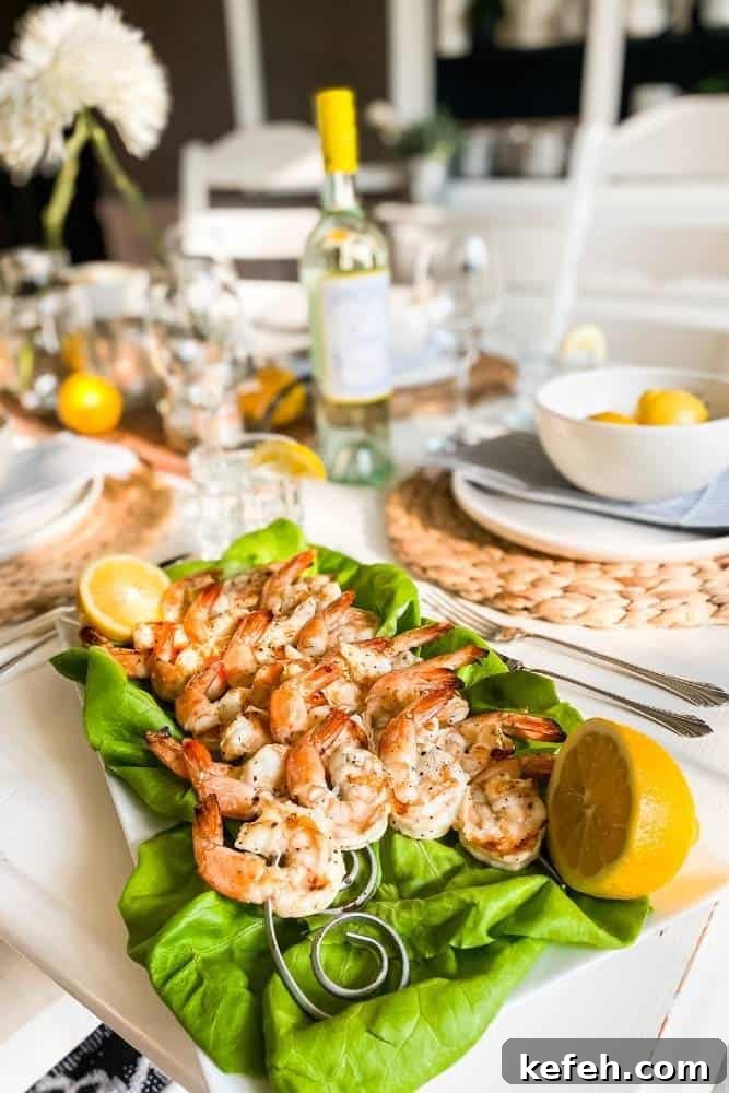 Fresh Summer Dinner Party Menu Ideas for Entertaining Guests 5 Table set for dinner with white dishes and lemons with a platter of grilled lemon pepper shrimp on a bed of lettuce