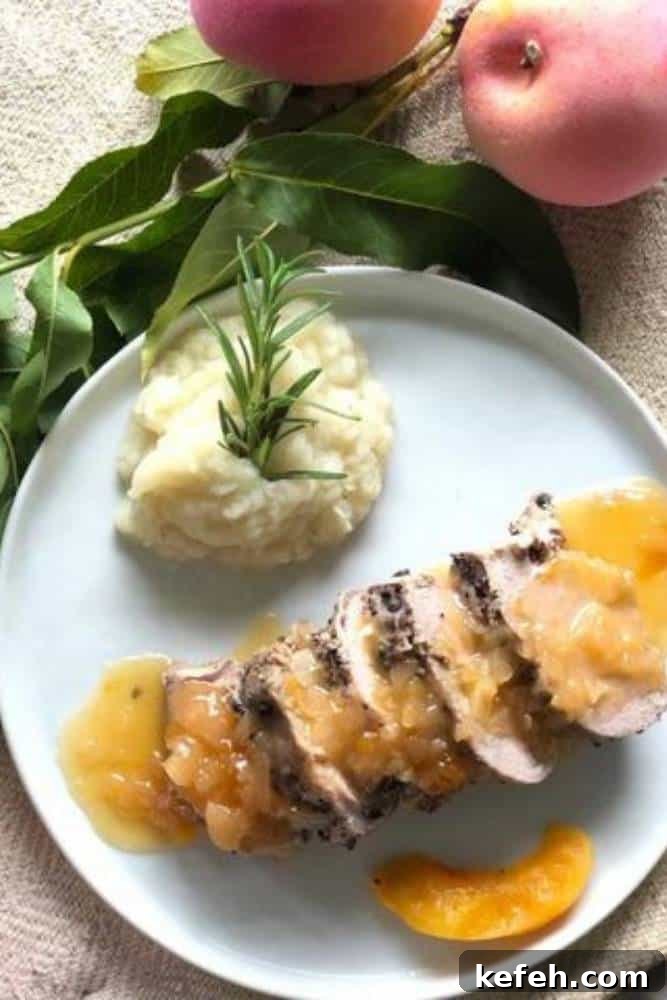 Fresh Summer Dinner Party Menu Ideas for Entertaining Guests 7 Plate with sliced pork tenderloin topped with peach sauce next to mashed potatoes garnished with fresh rosemary sprig