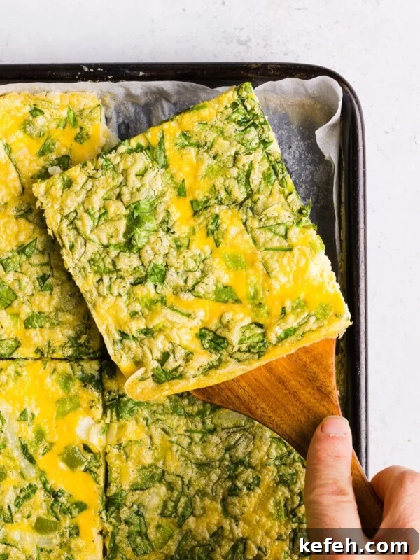 Fluffy Cottage Cheese Omelette Recipe for High-Protein Breakfast 2 A close up shot of a slice of sheet pan eggs for sandwiches.