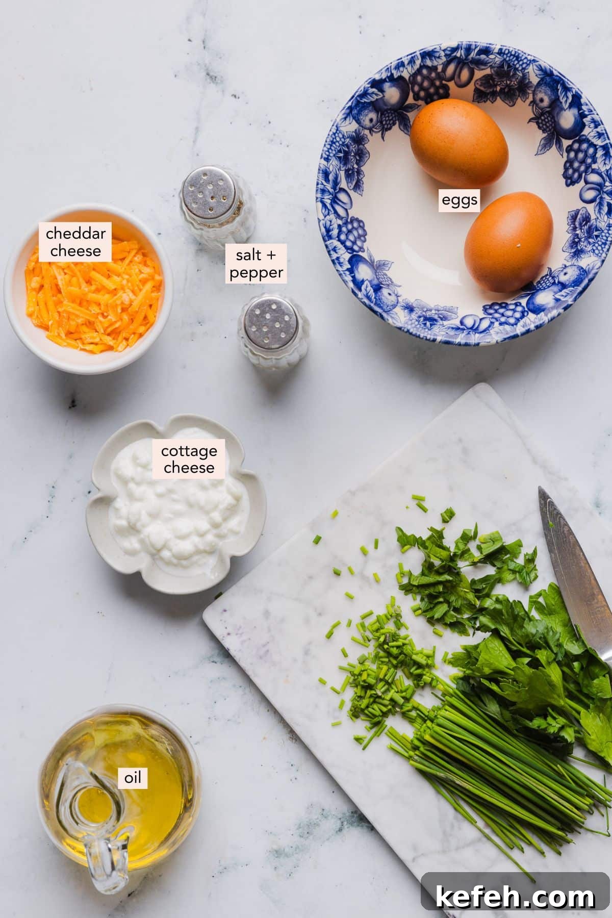 This easy cottage cheese omelette is loaded with creamy, salty cottage cheese and sharp cheddar. It's a protein powerhouse! Ingredients for a cottage cheese omelette on a countertop with labels.