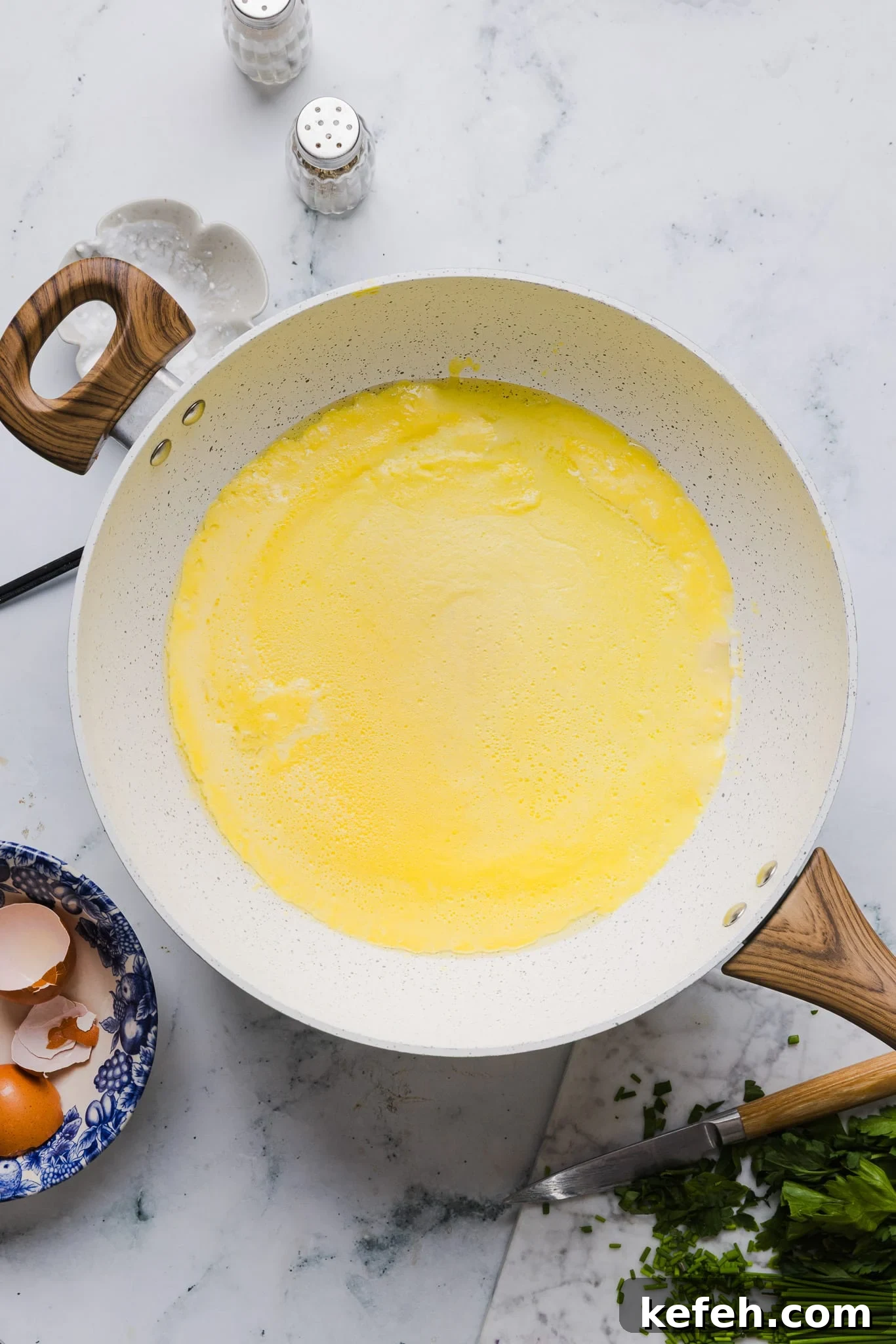 This easy cottage cheese omelette is loaded with creamy, salty cottage cheese and sharp cheddar. It's a protein powerhouse! Blended eggs, cottage cheese, and salt cooking in a skillet.