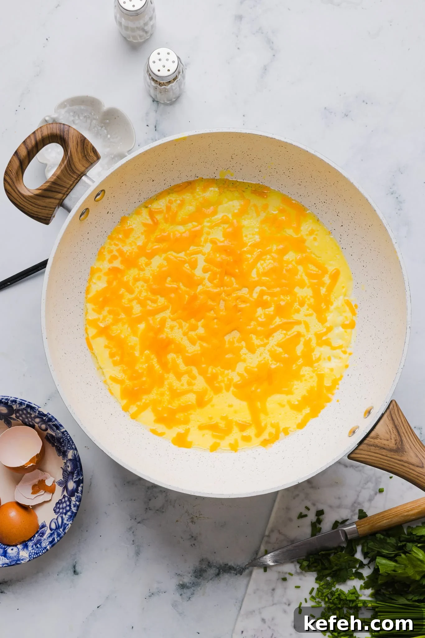 This easy cottage cheese omelette is loaded with creamy, salty cottage cheese and sharp cheddar. It's a protein powerhouse! Adding cheddar cheese to a cottage cheese omelette.