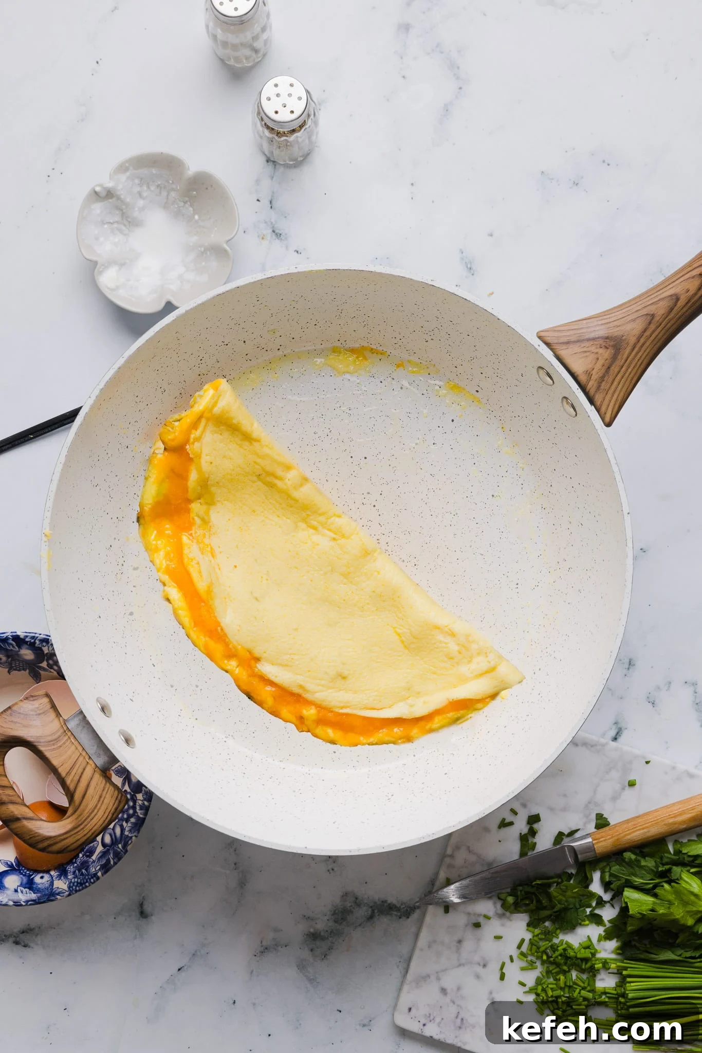 This easy cottage cheese omelette is loaded with creamy, salty cottage cheese and sharp cheddar. It's a protein powerhouse! A cottage cheese omelette in a skillet.
