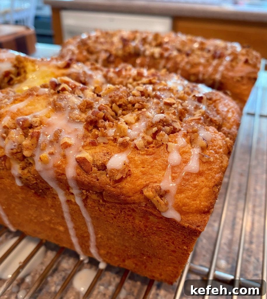 Quick Lemon Streusel Bread from Cake Mix 7 Lemon Streusel Bread on cooling baking racks with glaze drizzle.