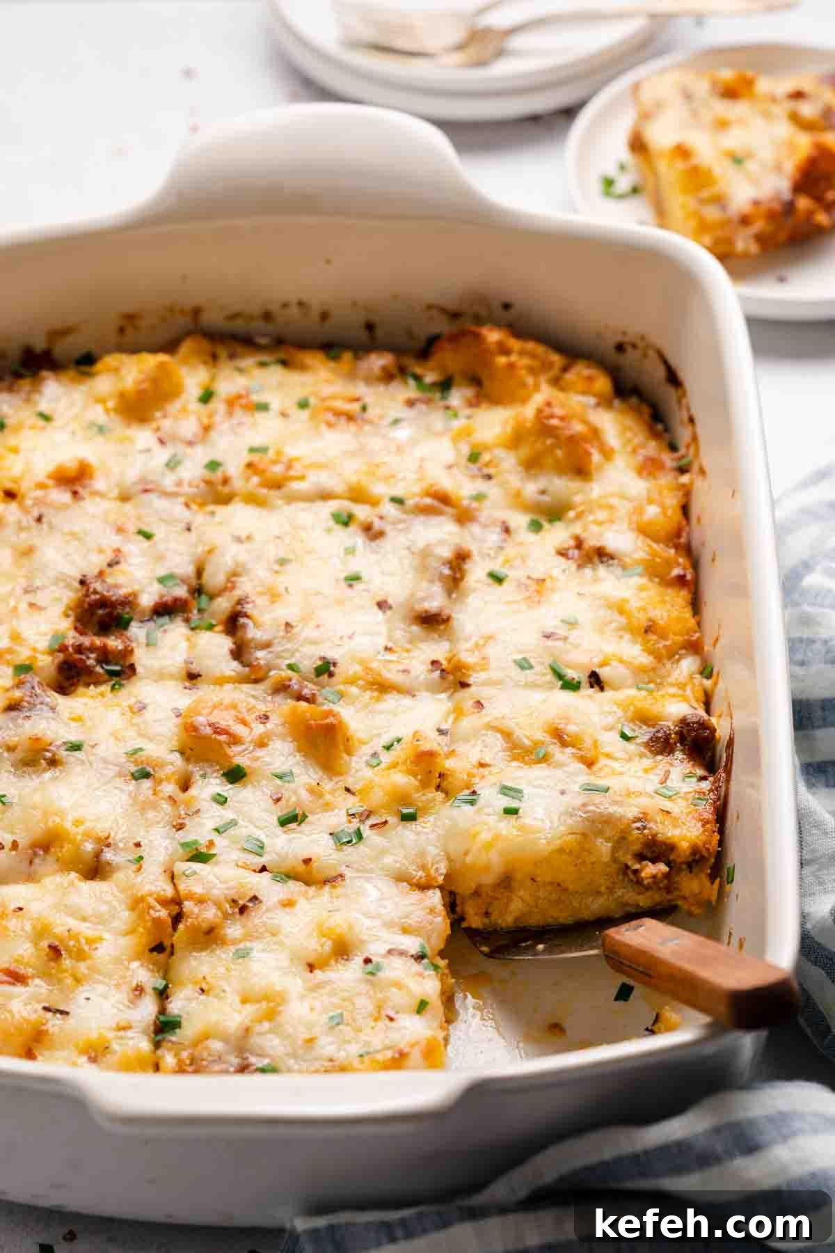Italian-style breakfast casserole in white pan with spatula