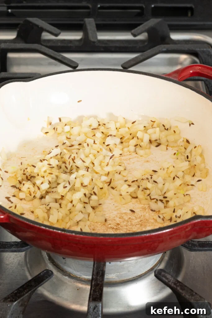 onions and cumin seeds in a pan