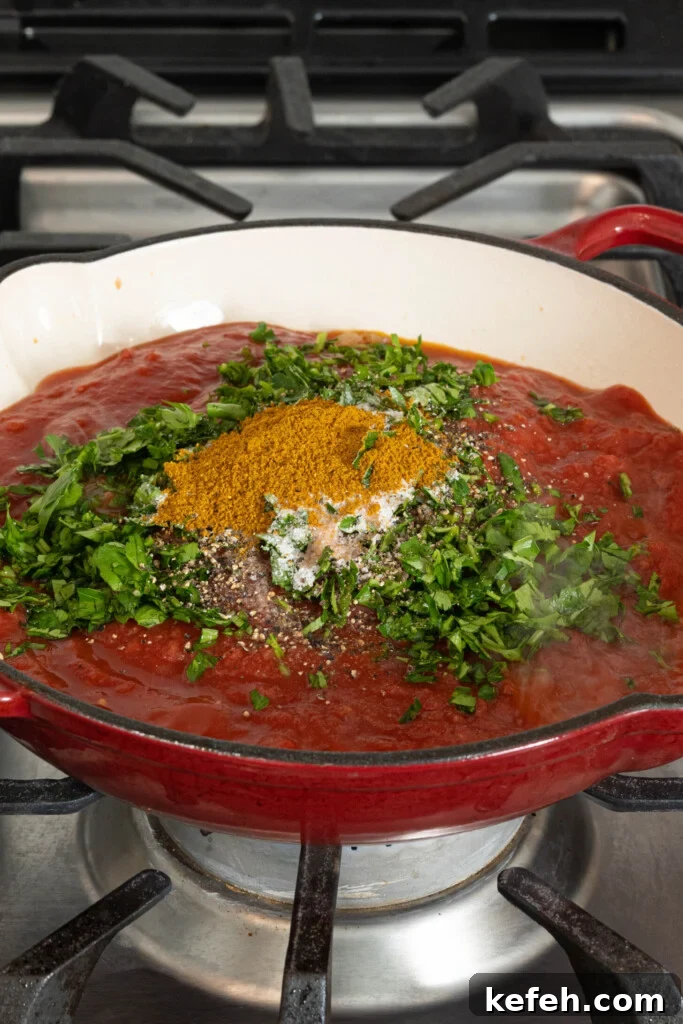 tomato sauce with herbs and spices in a pan