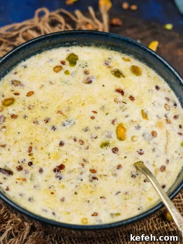 A bowl of creamy Sheer Khurma garnished with chopped nuts.