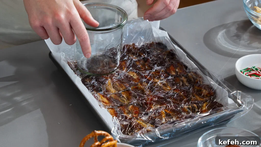 Chocolate Bark with Dates, Pecans and Pretzels: Sweet & Salty Snack 4 Pressing dates into a parchment lined cookie sheet for this chocolate date bark recipe.
