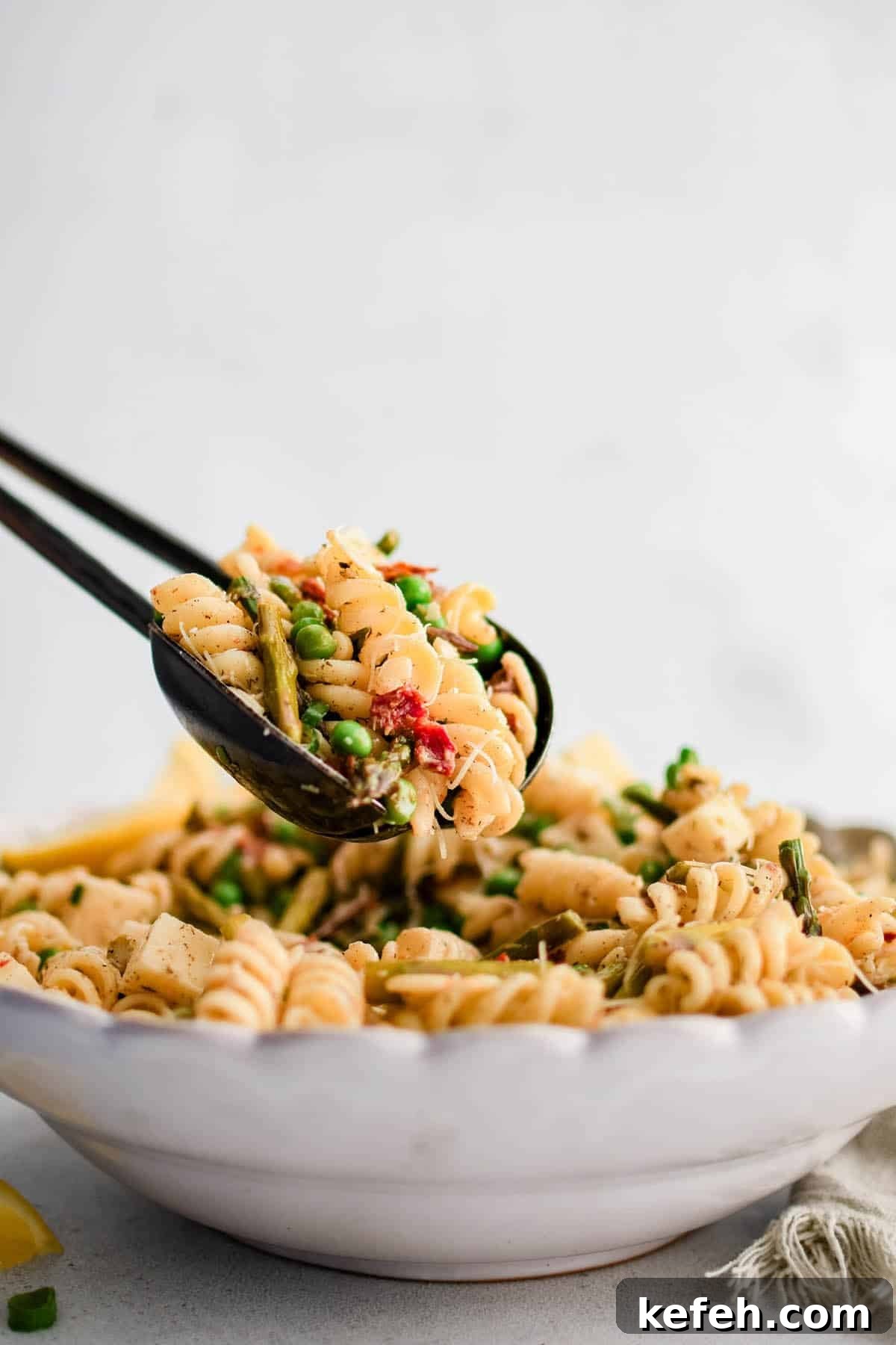 Roasted Asparagus Pasta Salad with Lemon Garlic Vinaigrette 4 roasted asparagus pasta salad in a pair of serving tongs