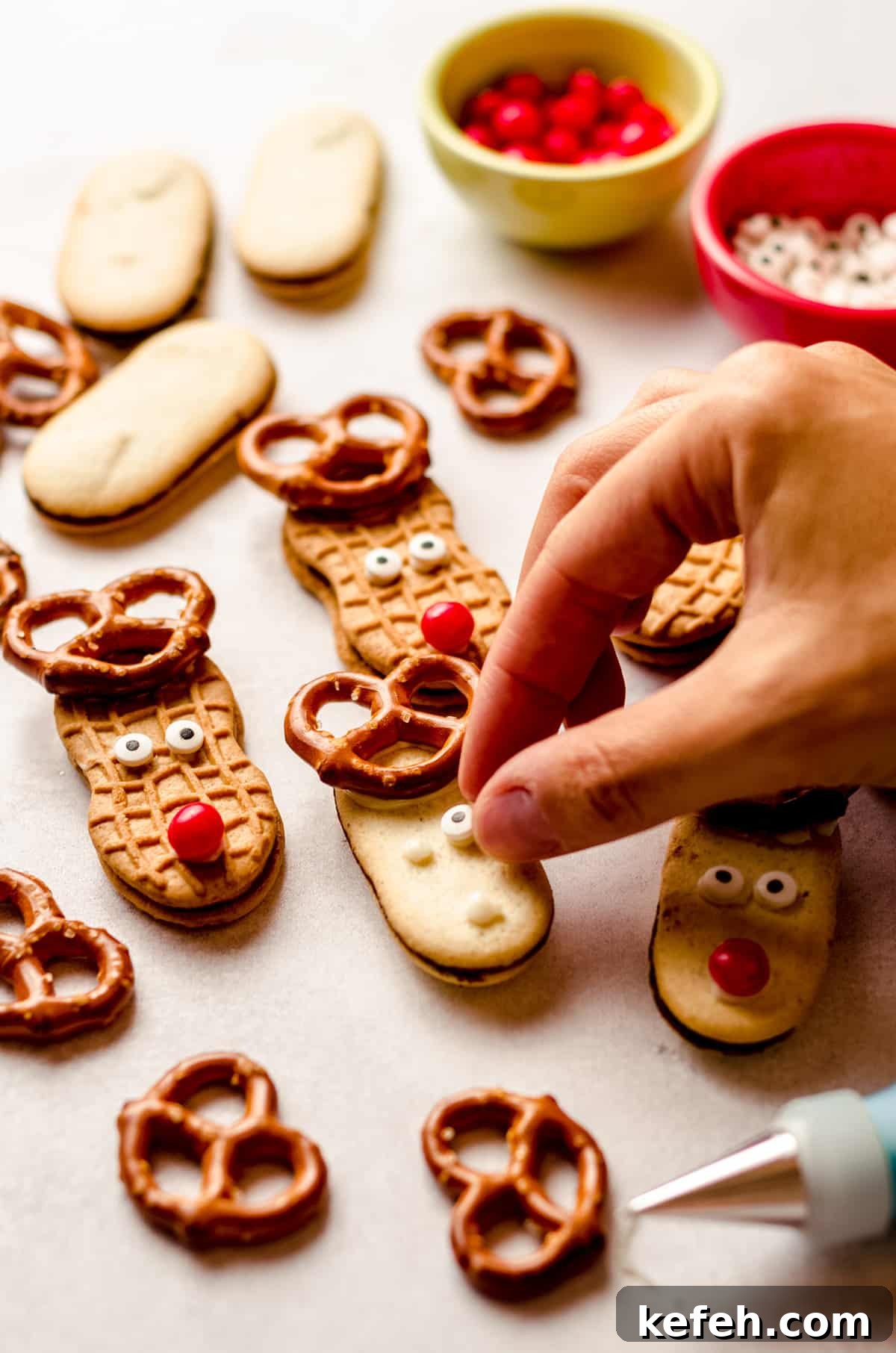 Festive Reindeer Sugar Cookies Recipe for Holiday Baking 6 hand placing eyes on reindeer cookies
