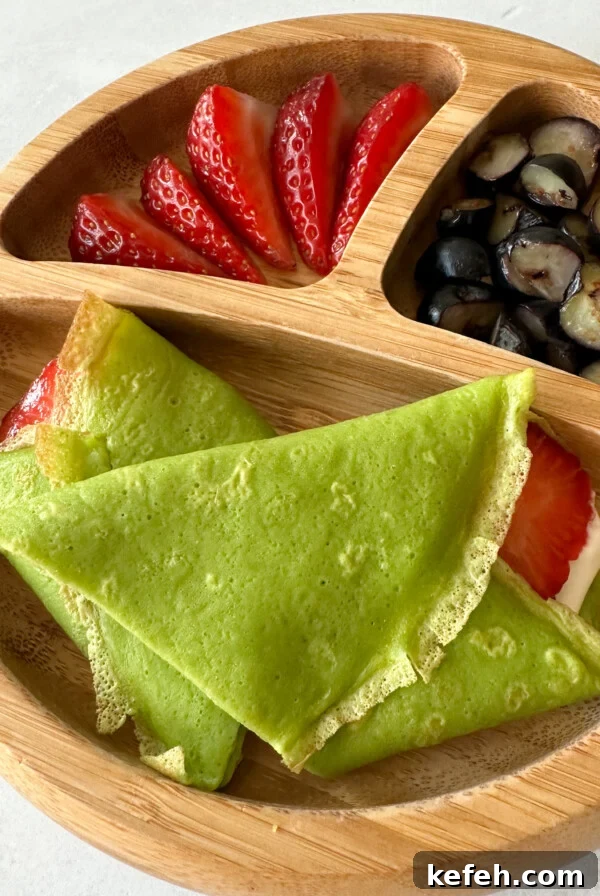Spinach and Apple Baby Puffs — Homemade Toddler Snack Recipe 11 Spinach crepes filled with yogurt and strawberries.