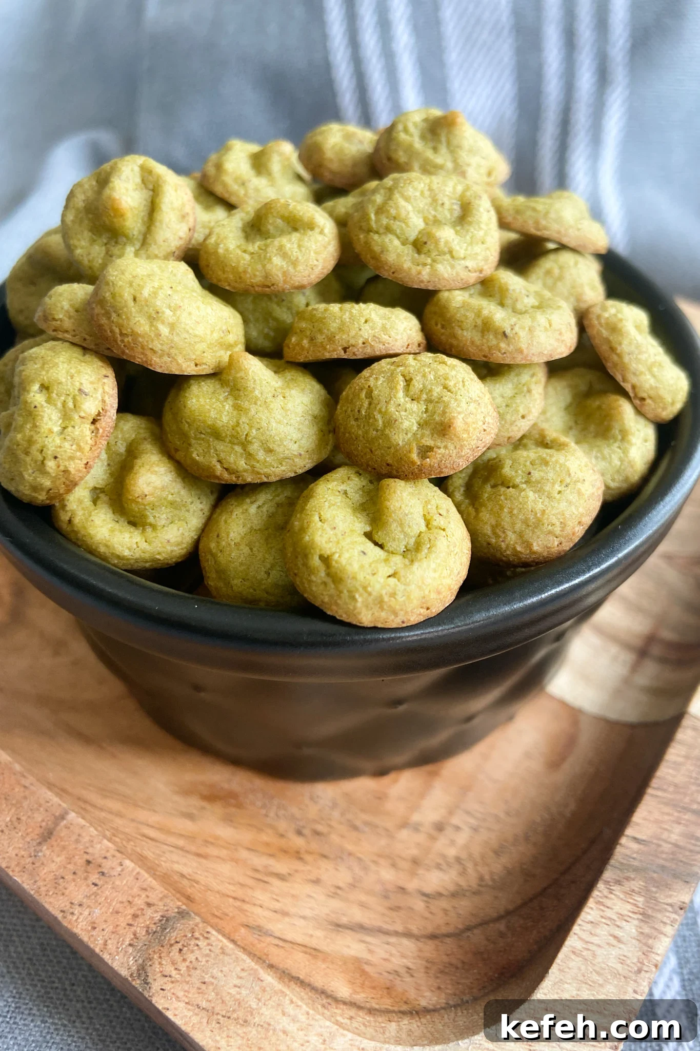 Spinach and Apple Baby Puffs — Homemade Toddler Snack Recipe 6 Spinach banana puffs served in a black container