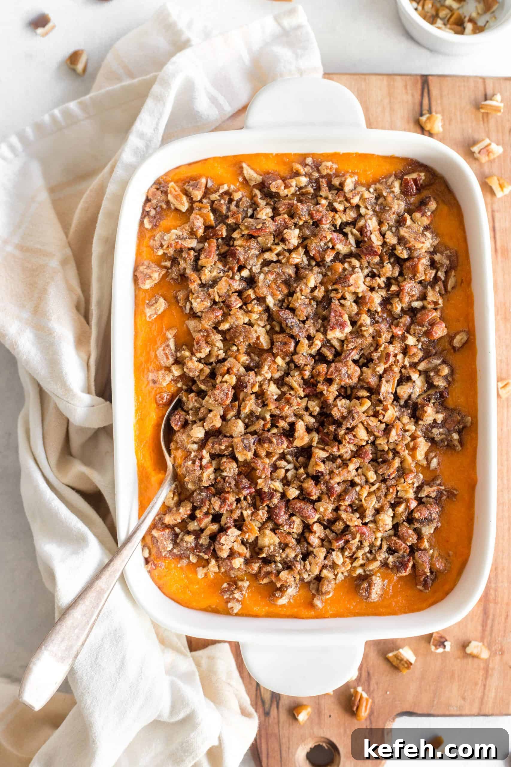 Gluten Dairy-Free Sweet Potato Casserole Top down view of a gluten-free sweet potato casserole on a wooden board.