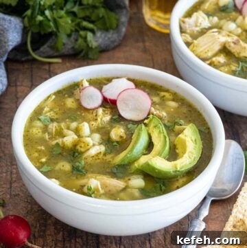Bowls of pozole verde, topped with sliced avocados and radishes