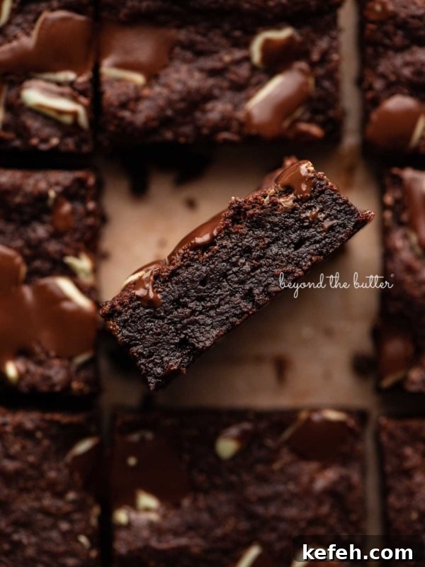 Creamy No-Bake Mint Chocolate Pie Recipe 9 Double chocolate mint brownies on brown parchment paper background with the center brownie on its side.