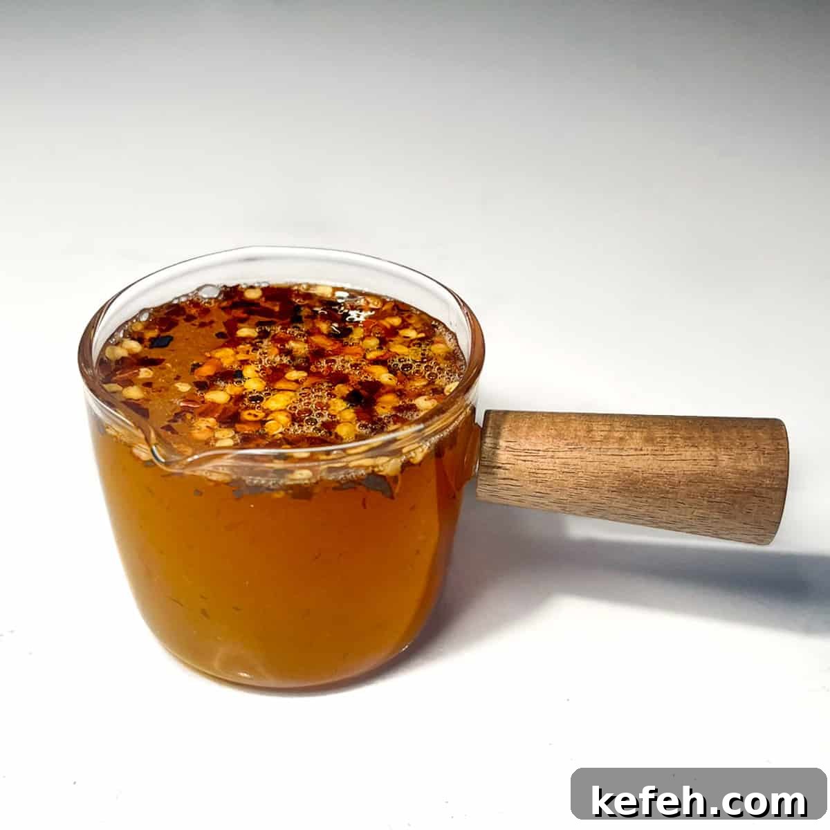 Hot honey dressing in a small sauce pot.