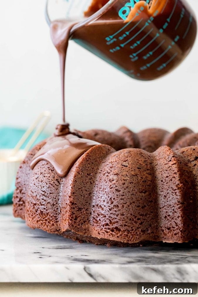Moist Chocolate Bundt Cake Recipe (Video Tutorial) 5 Pouring chocolate glaze over bundt cake