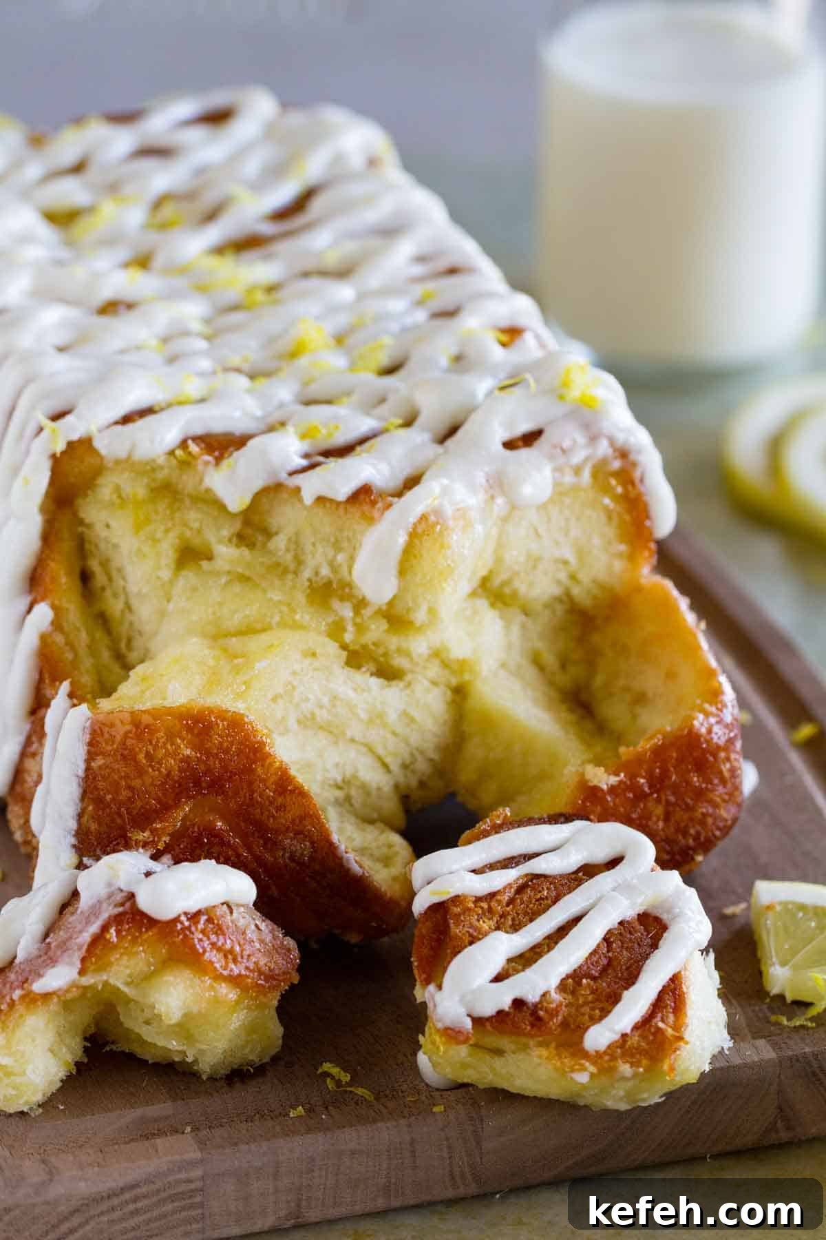 Loaf of lemon roll pull apart bread with pieces taken off.