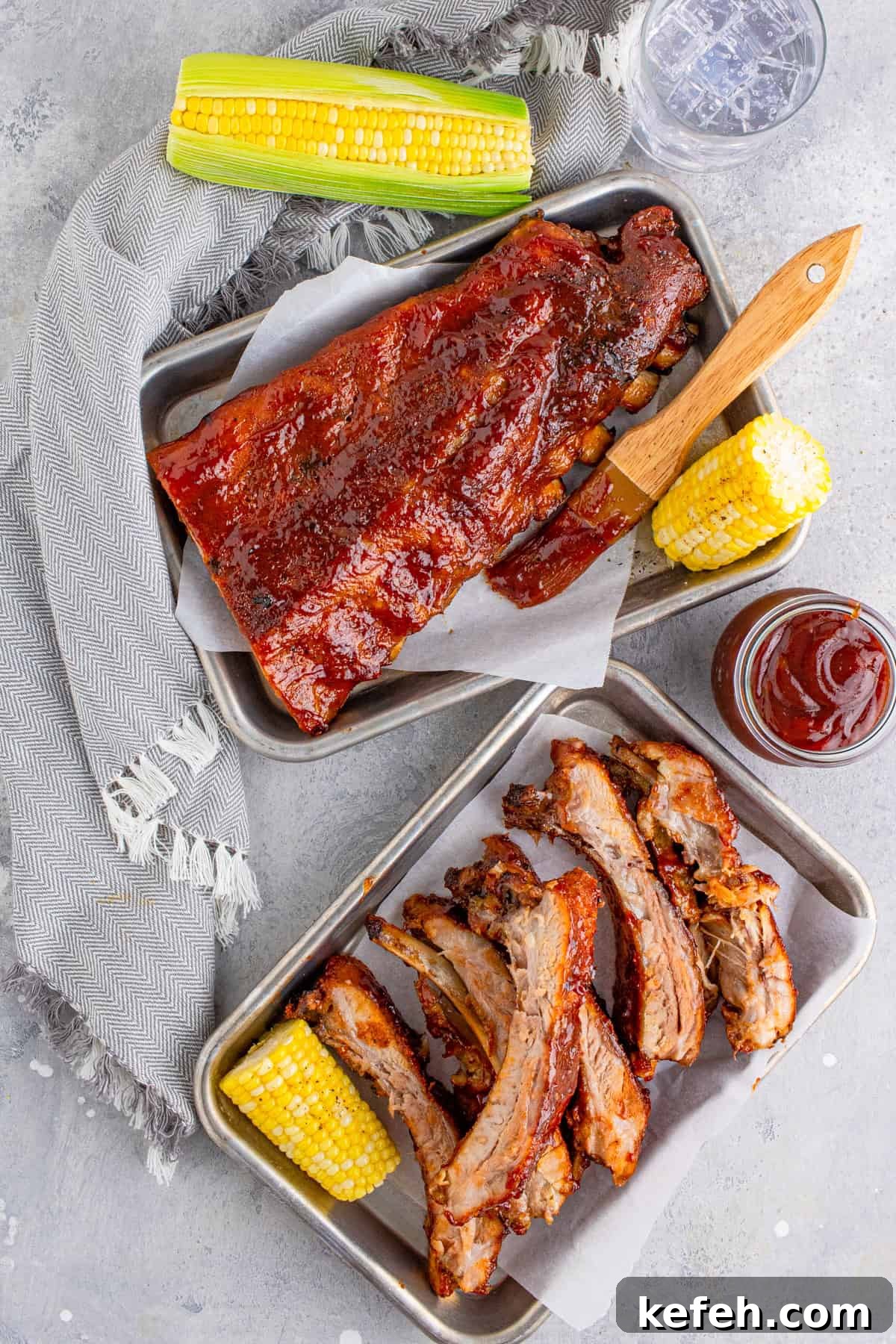 Overhead of BBQ Rib Recipe on metal platters with corn and bbq sauce