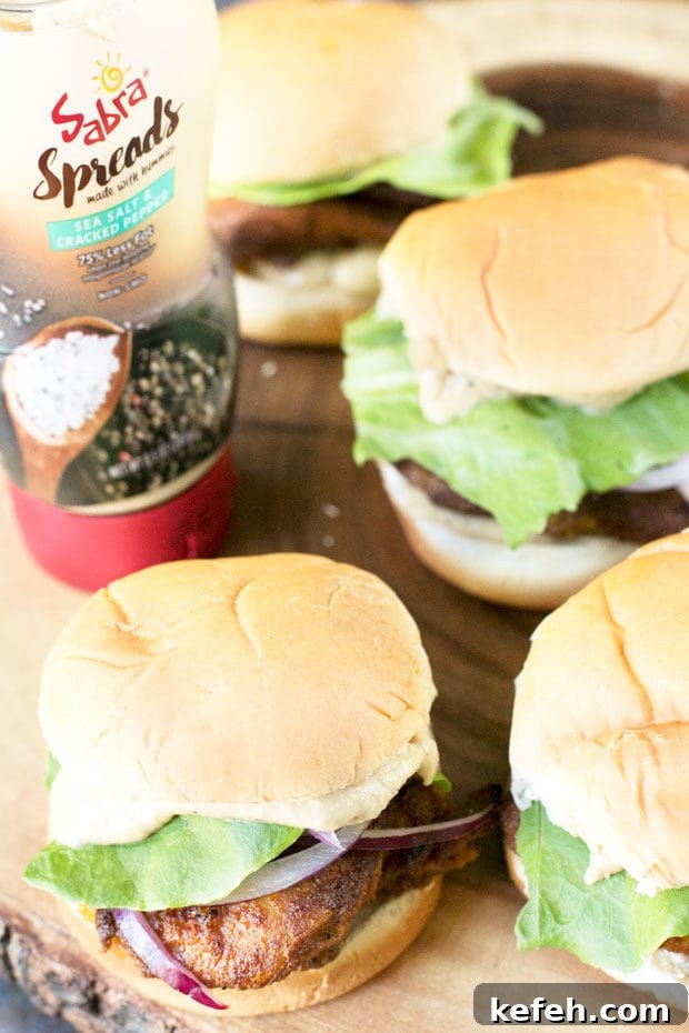 Juicy Chicken Shawarma Sliders with Garlic Sauce 4 Chicken Shawarma Sliders on a platter