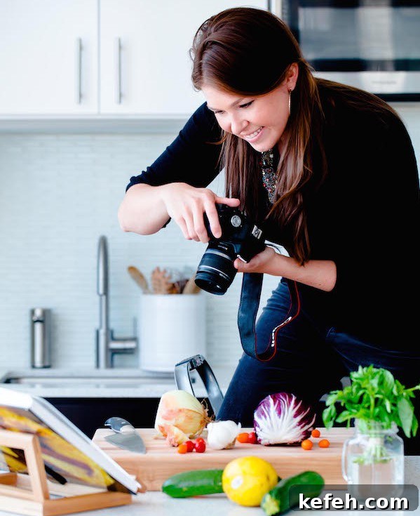 Woman Photographing A Recipe In a Kitchen