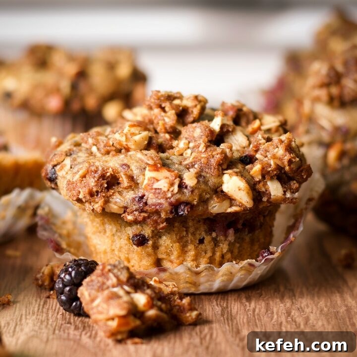A blackberry muffin piled high with oatmeal streusel.