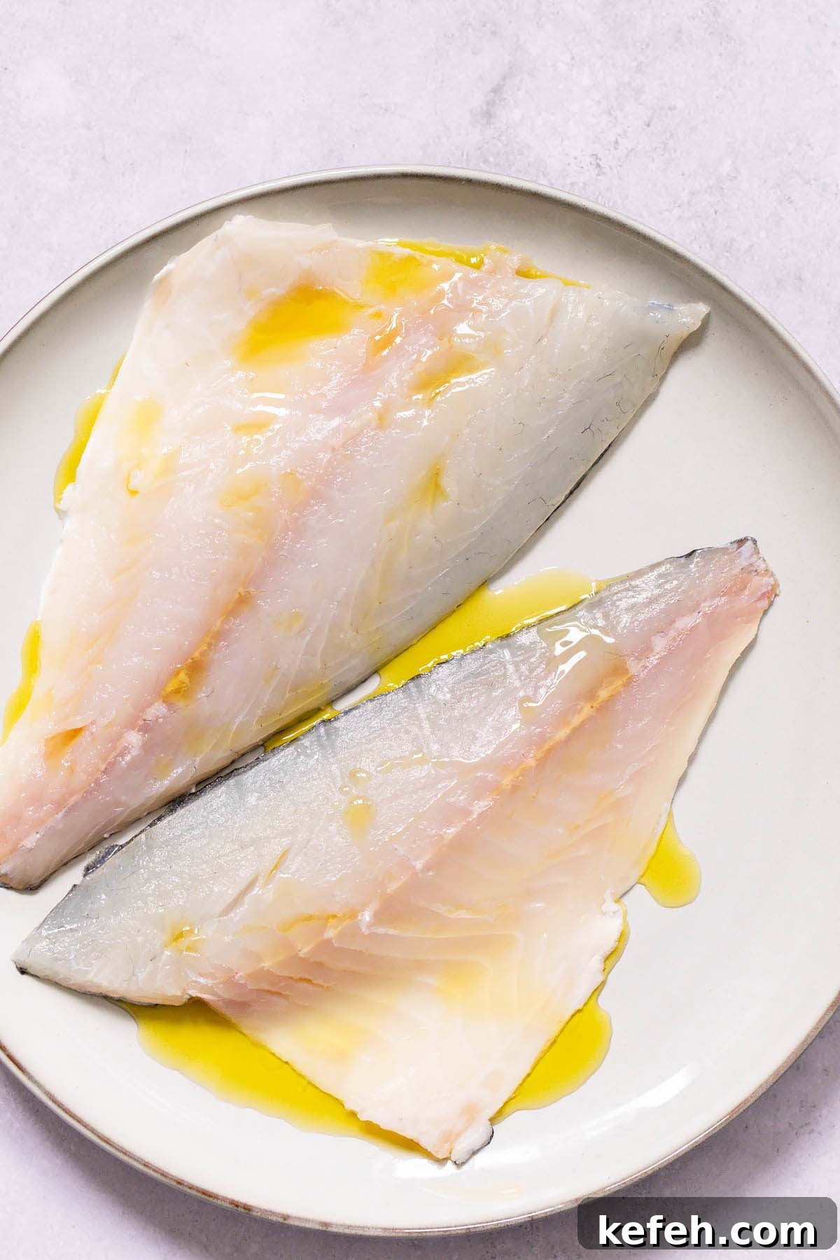 Crispy Air-Fryer Sea Bream Fillets with Lemon 3 Drizzling olive oil on sea bream fillets