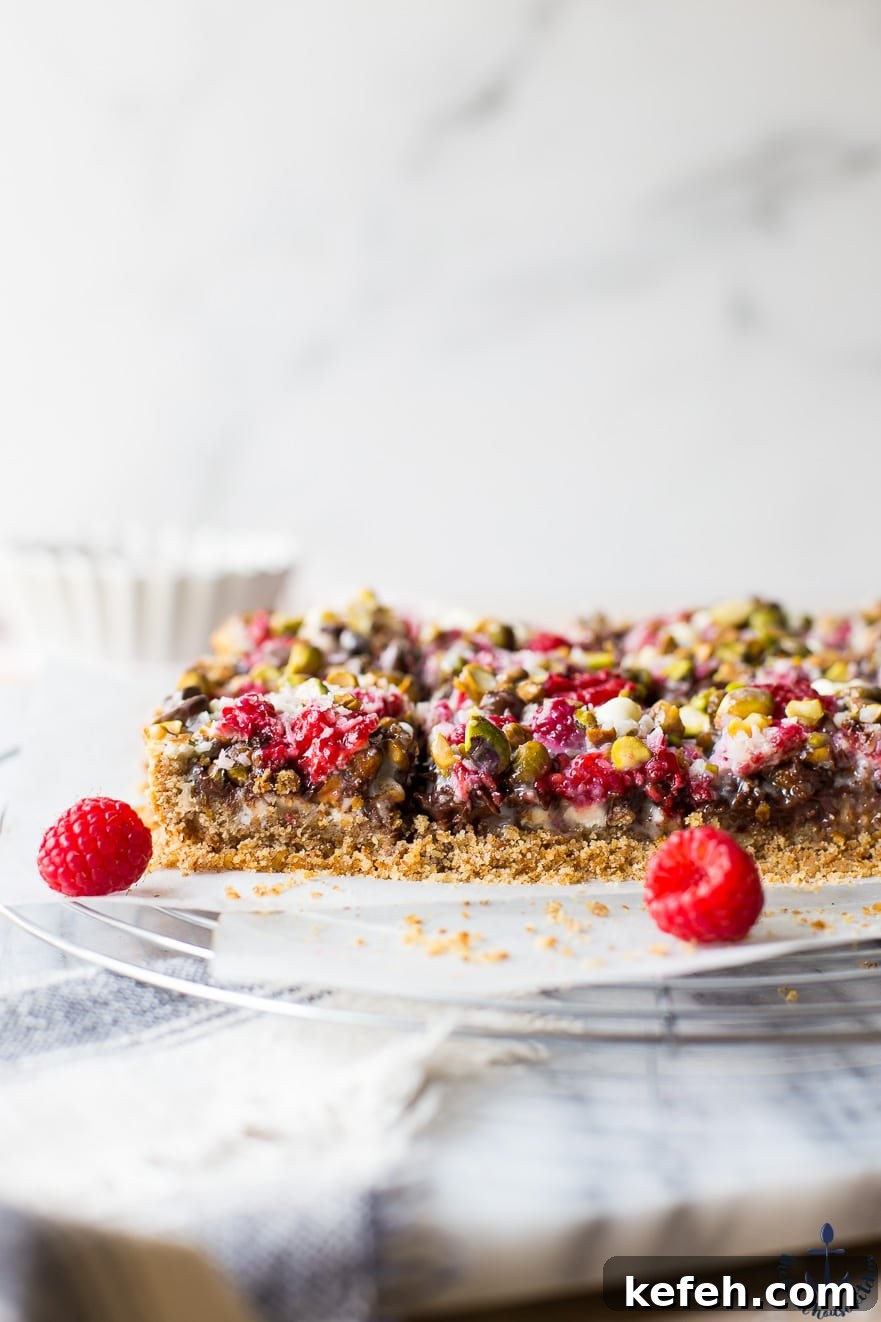 Raspberry Pistachio Bars with two raspberries