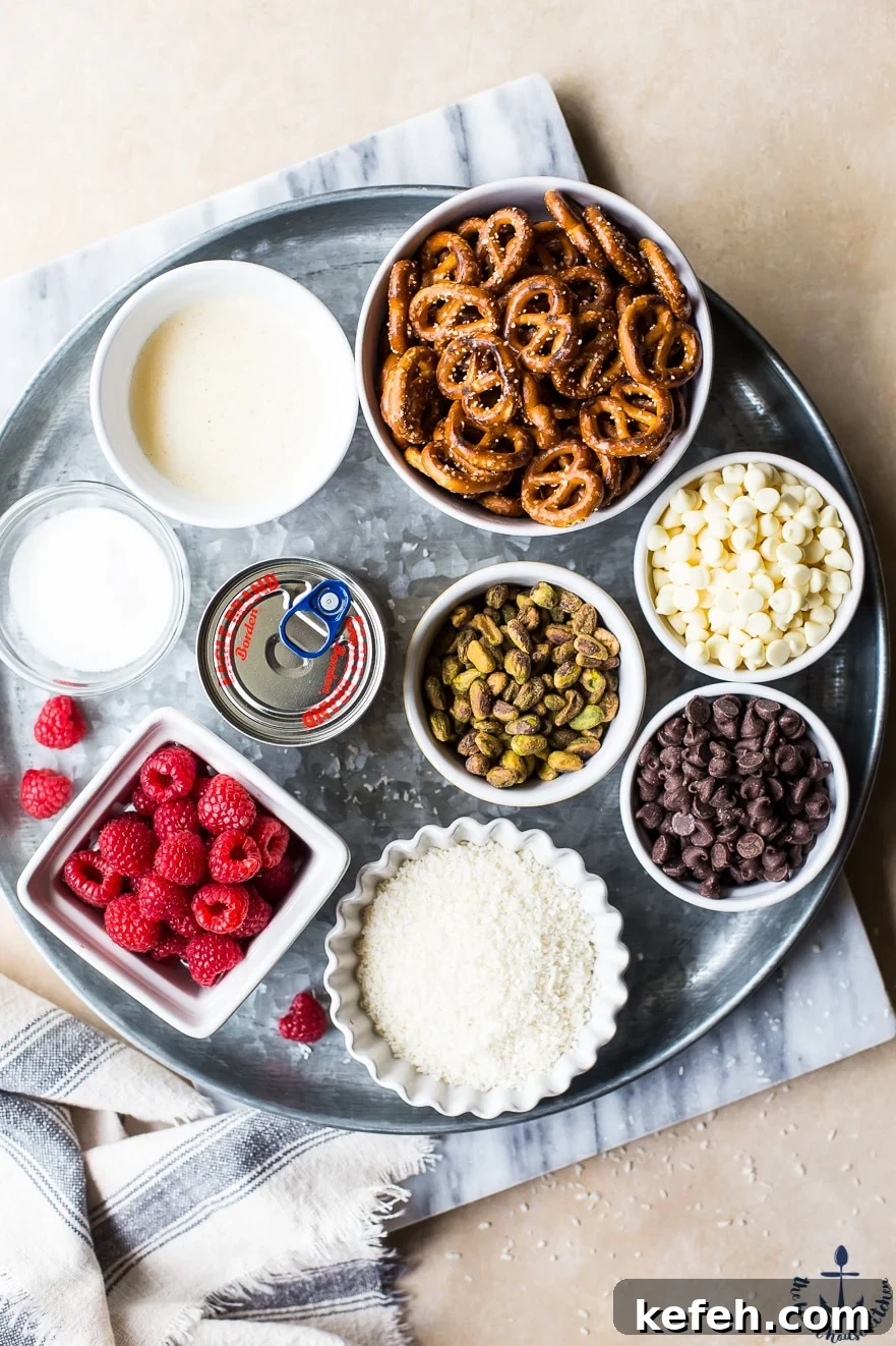 Overhead photo of ingredients for raspberry pistachio magic bars on a silver tray
