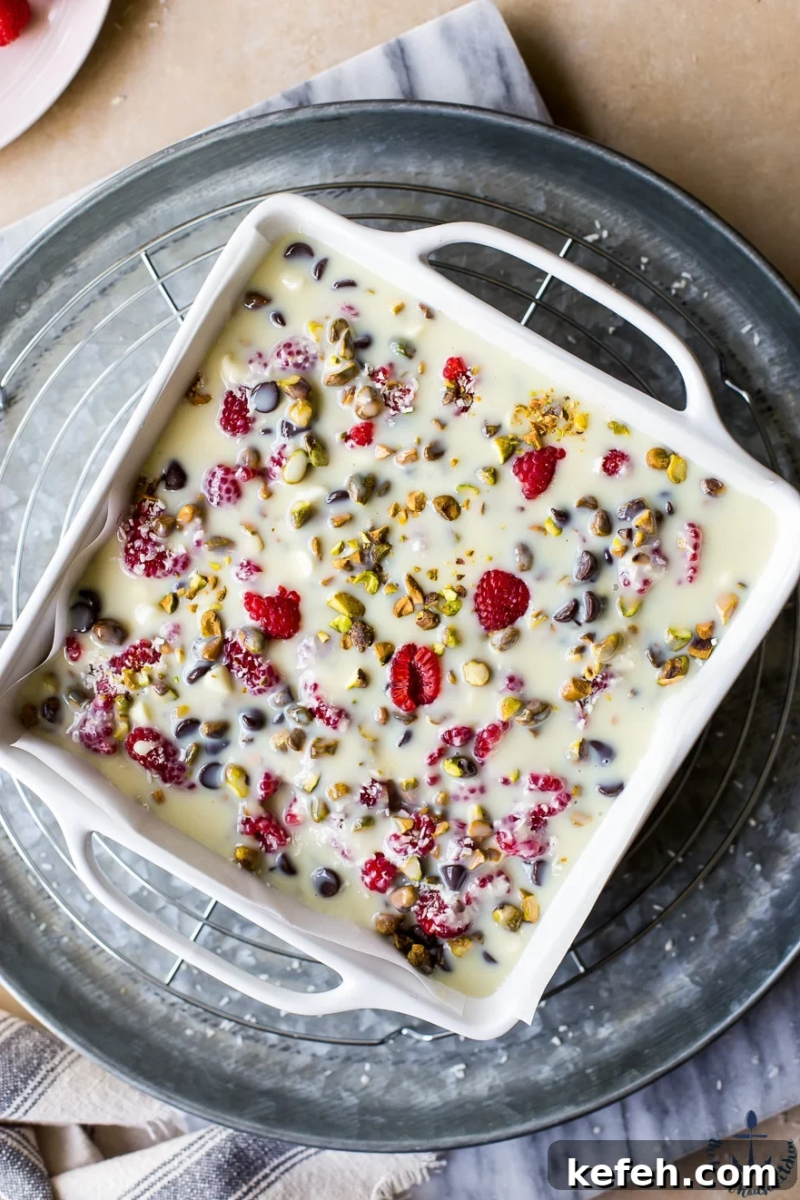 Overhead photo of unbaked raspberry pistachio magic bars