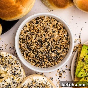 Everything Bagel Seasoning in a small bowl surrounded by bagels and avocado toast.