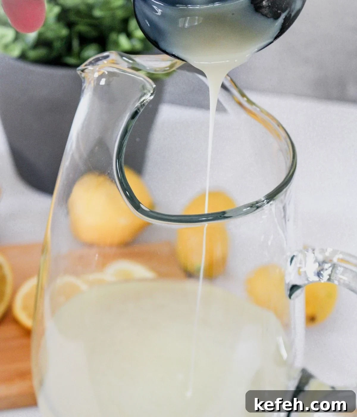 Pitcher of lemon juice and water, pouring sweetened condensed milk into pitcher.