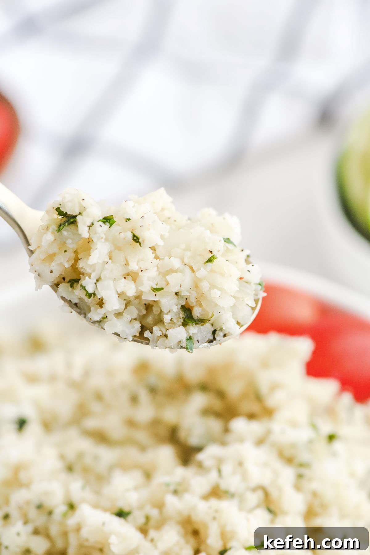 Cilantro Lime Cauliflower Rice Recipe for Flavorful Low-Carb Sides 10 A close-up of a spoonful of cilantro cauliflower lime rice.