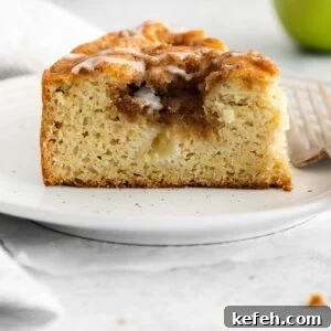 A close up photo of a slice of apple cake on a plate